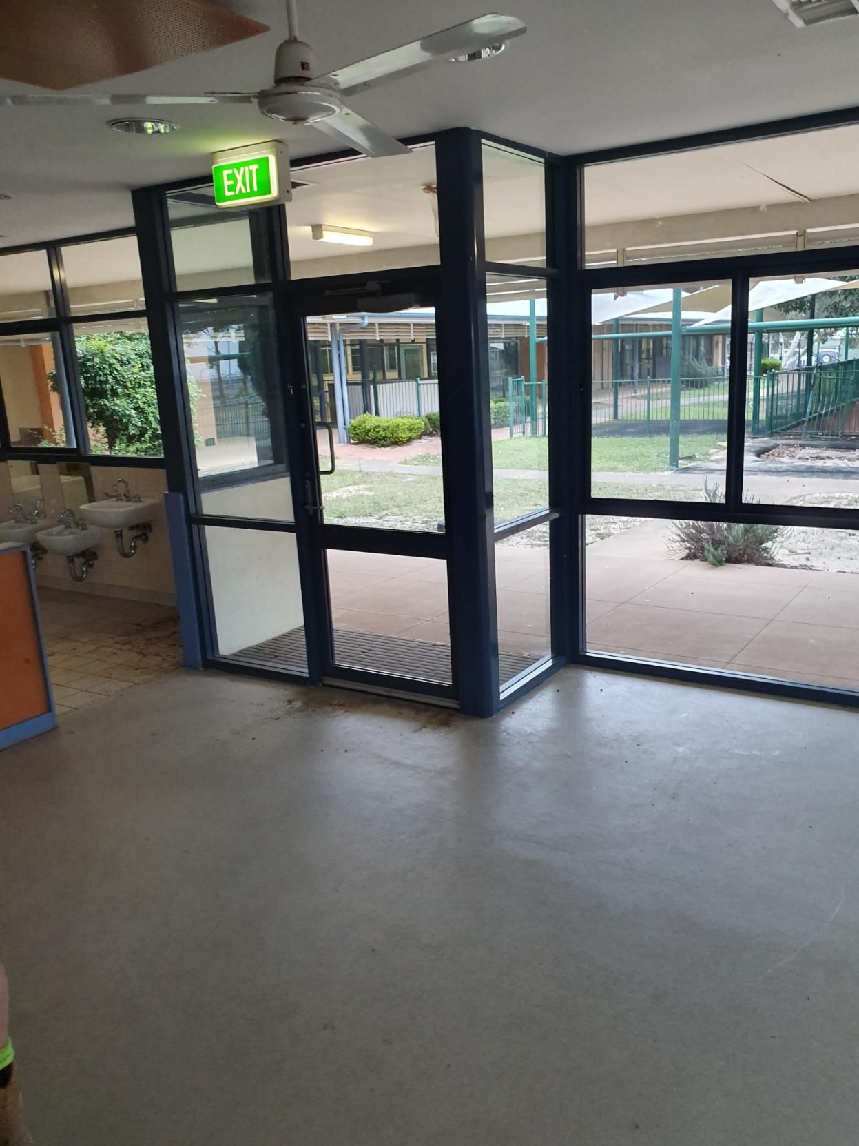 A Room with A Lot of Windows and A Green Exit Sign — Entire Trades in Singleton, NSW