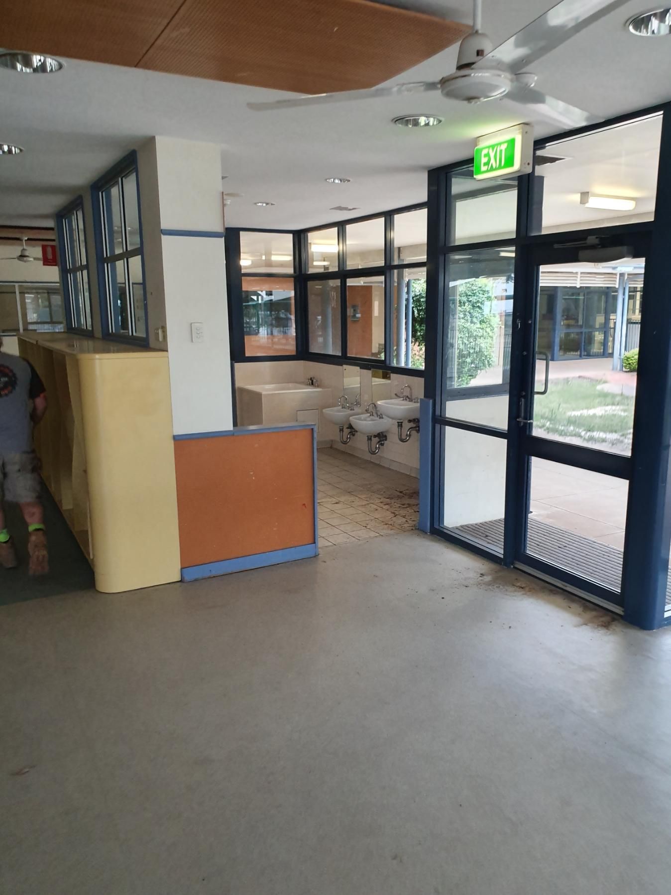 An Empty Room with A Green Exit Sign on The Wall — Entire Trades in Singleton, NSW