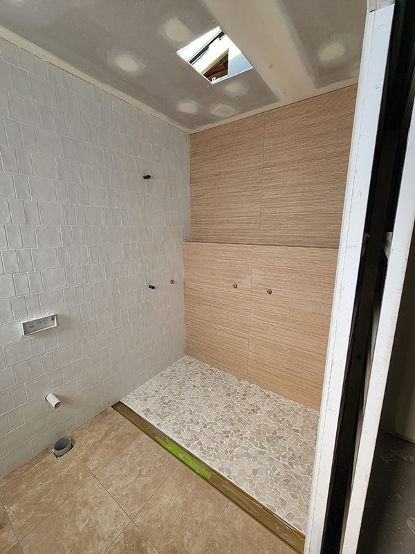 A Bathroom With A Walk-in Shower Under Construction — Entire Trades in Singleton, NSW