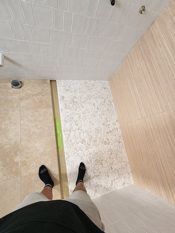 A Person Standing In A New Bathroom Under Construction — Entire Trades in Singleton, NSW