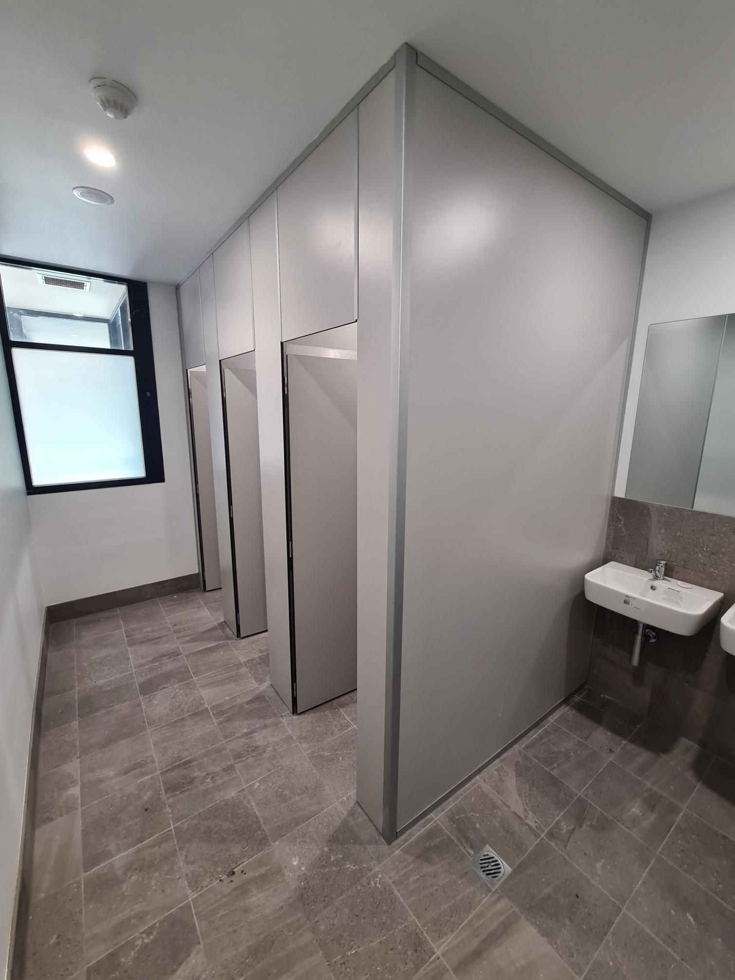A Bathroom with A Sink and A Mirror in It — Entire Trades in Maitland, NSW