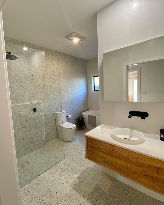Bathroom With Sink, Toilet And Shower Room With Light Open — Entire Trades in Singleton, NSW
