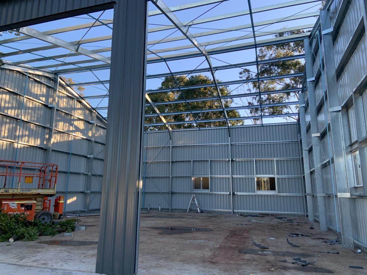 The Inside of A Building Under Construction with A Ladder in The Foreground — Entire Trades in Maitland, NSW