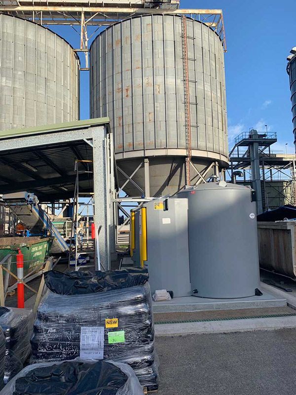A Large Warehouse With Gray Tanks And Black Wiring Cable — Entire Trades in Cessnock, NSW