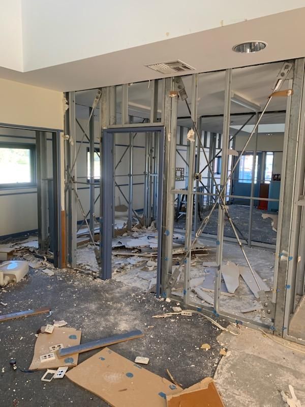 A Room that Is Being Remodeled with Cardboard Boxes on The Floor — Entire Trades in Maitland, NSW
