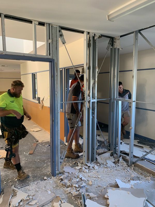 Workers Constructing Building With Metal Frames At Construction Site — Entire Trades in Port Stephens, NSW