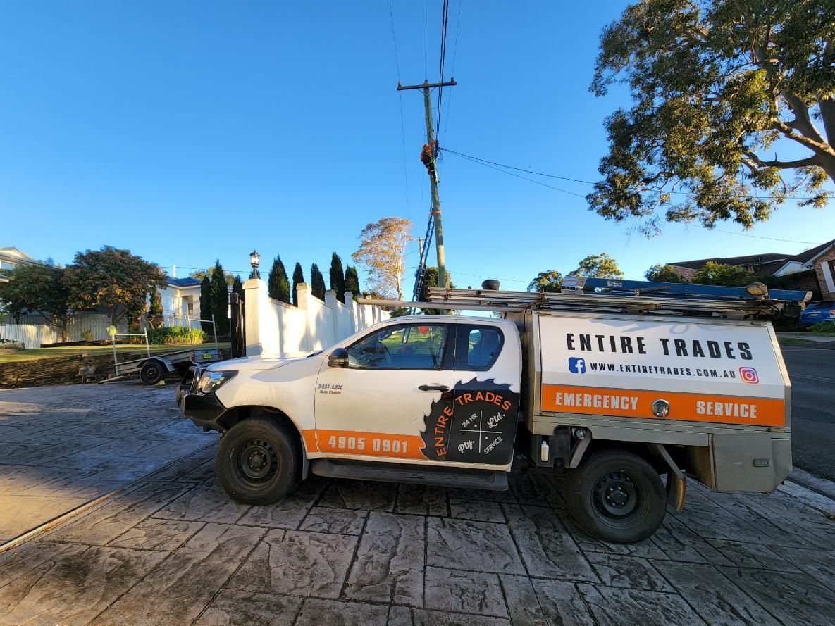 A White Truck Is Parked on The Side of The Road — Entire Trades in Maitland, NSW