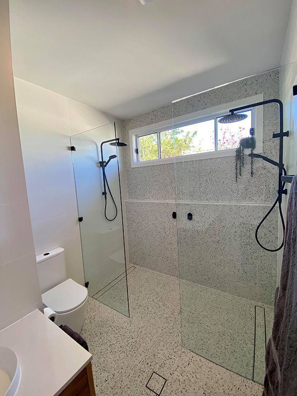 A Bathroom With Shower Screen And Toilet — Entire Trades in Singleton, NSW