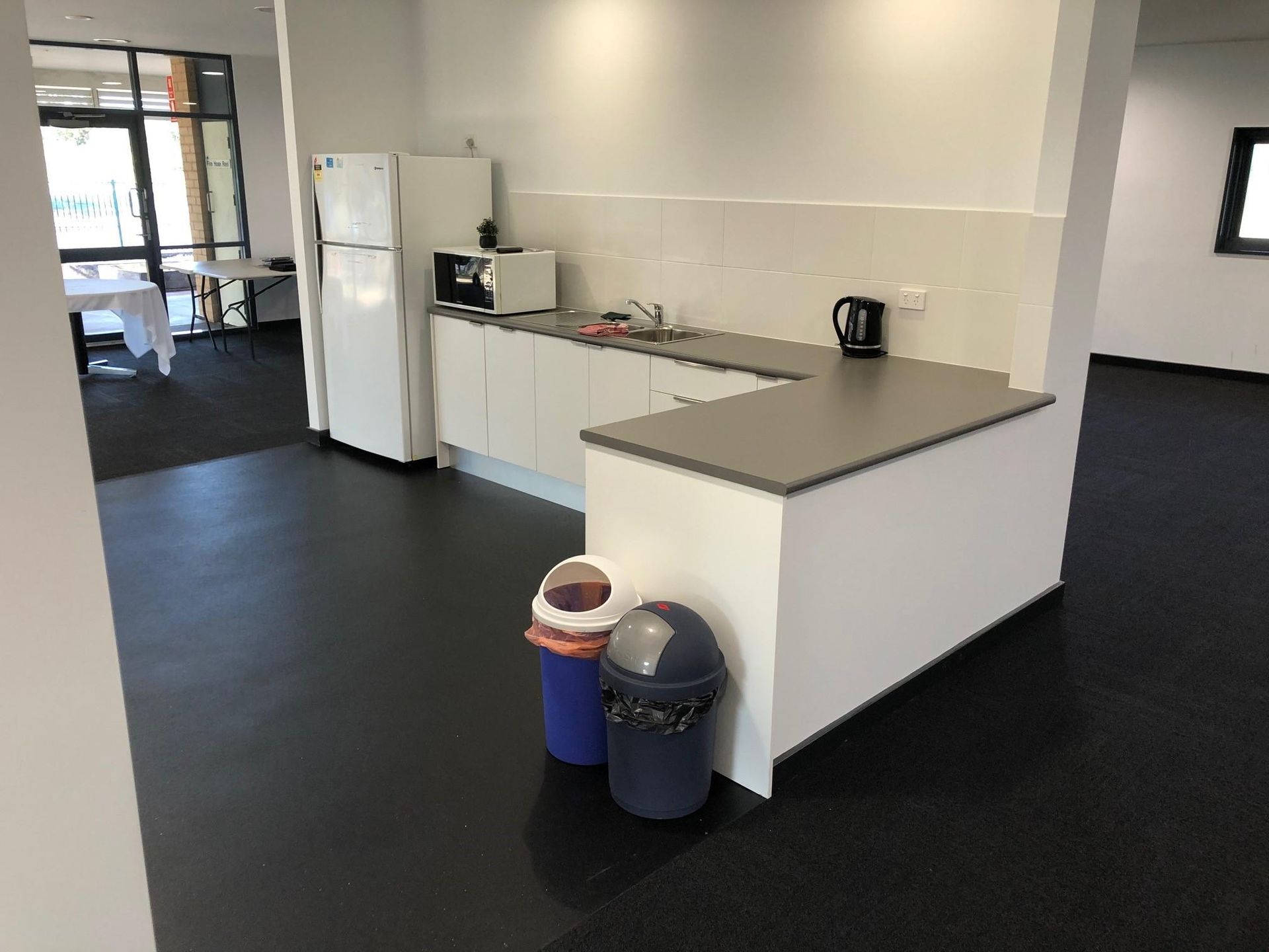 A Kitchen with A Refrigerator , Sink , and Trash Cans — Entire Trades in Maitland, NSW