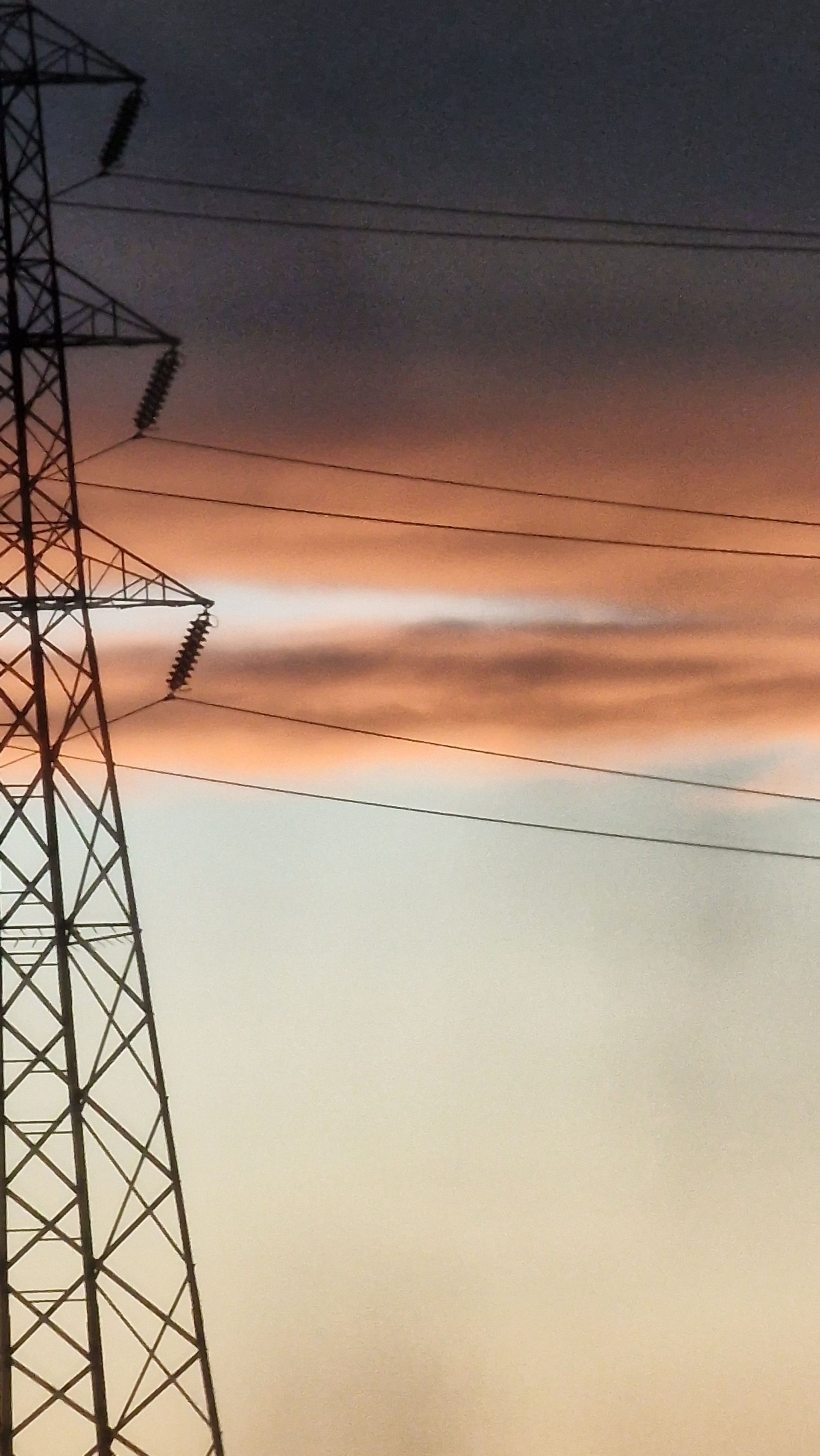 Silhouetted power lines and tower in Newcastle