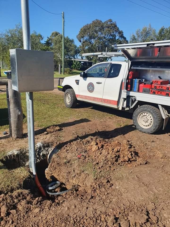 A White Truck Is Parked in The Dirt Next to A Box — Entire Trades in Maitland, NSW