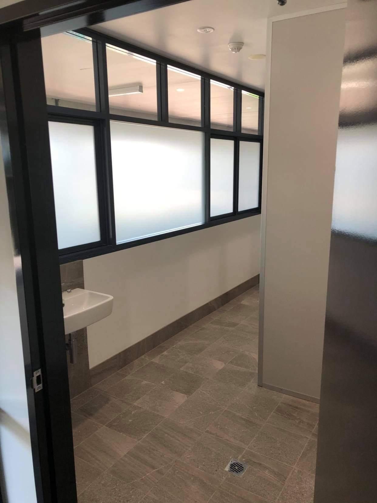 A Bathroom with A Sink and A Sliding Glass Door — Entire Trades in Maitland, NSW