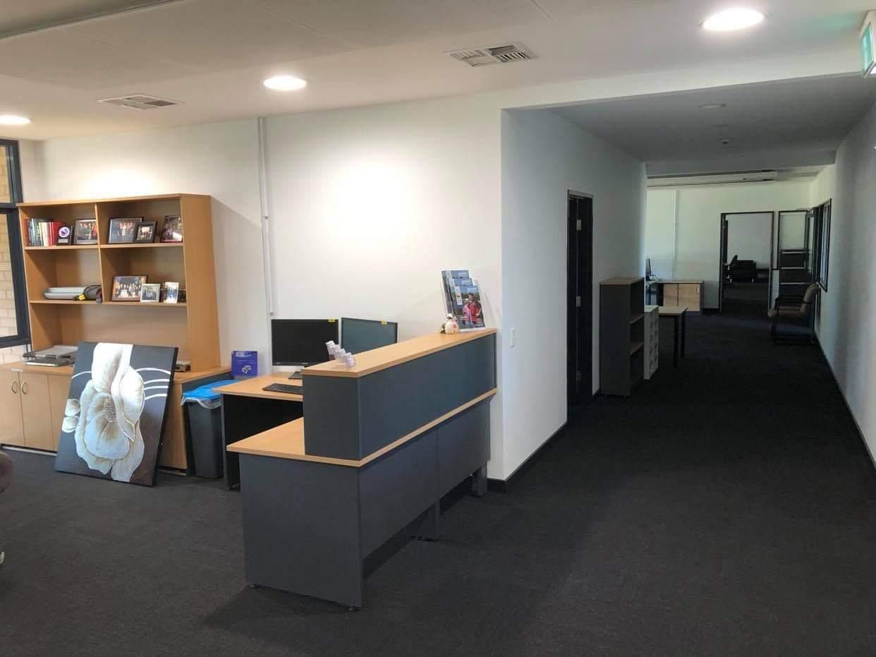 A Long Hallway with A Desk in The Middle of It — Entire Trades in Maitland, NSW