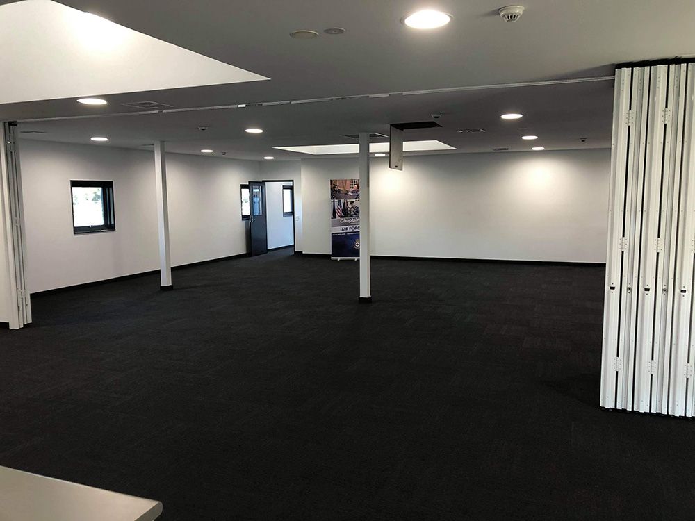 Office Interior With Black Carpet And White Walls Newly Renovate — Entire Trades in Port Stephens, NSW