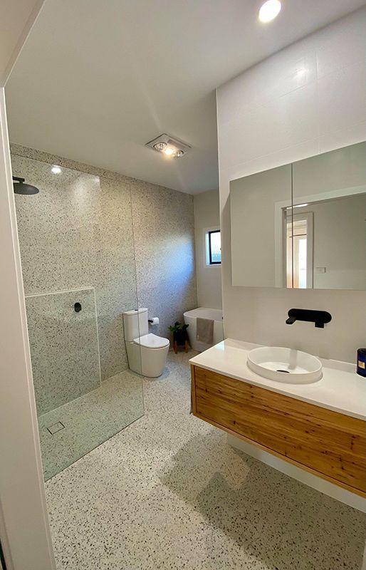 A Bathroom With A Sink, Toilet, Shower And Mirror With Emergency Lights — Entire Trades in Singleton, NSW