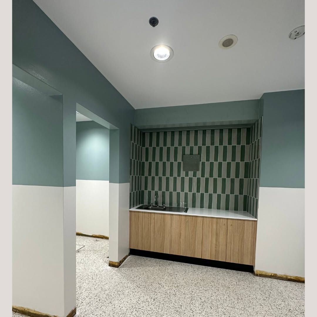 Room with Green and White Walls and Open Light Bulb