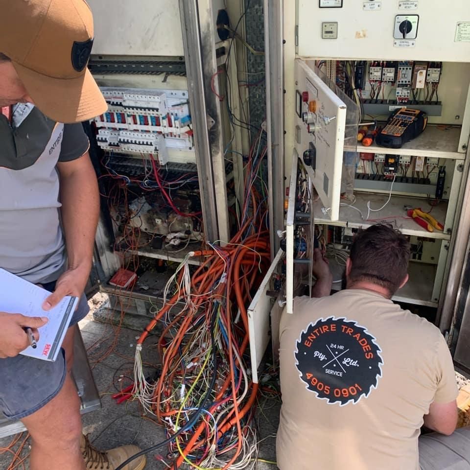 A Man Fixing Electrical Board — Entire Trades in Maitland, NSW