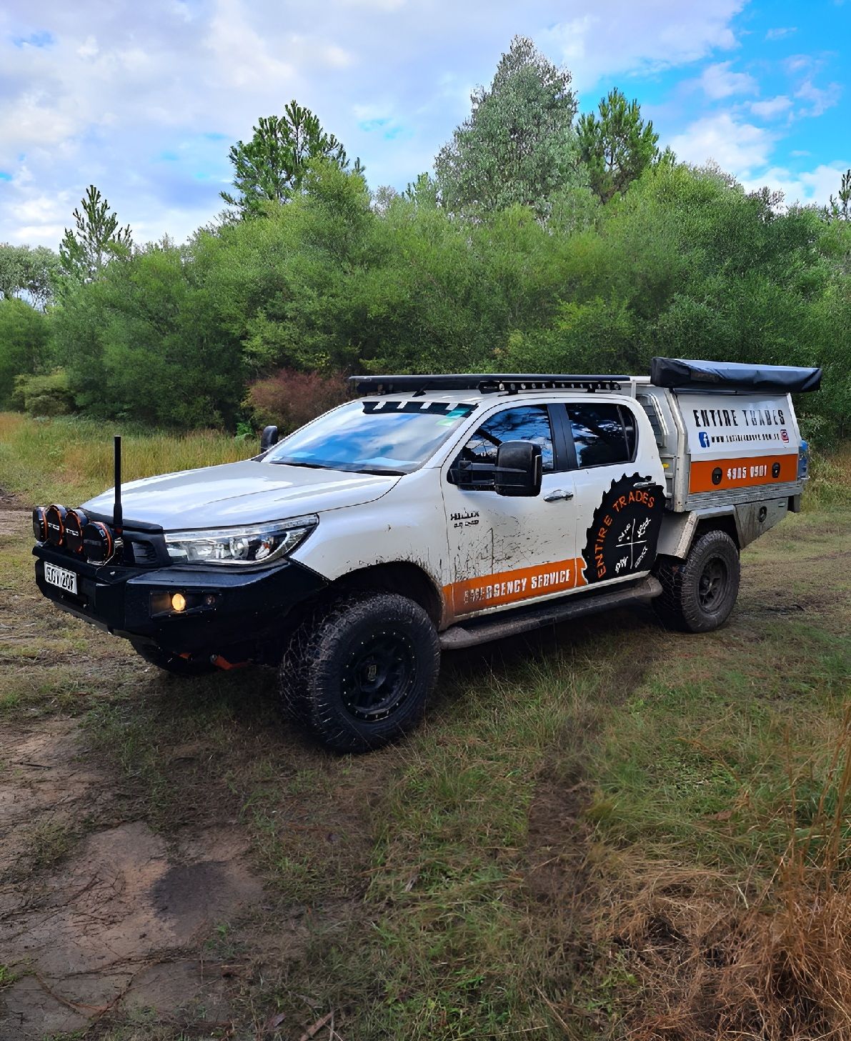 White Off-Road Pickup Truck Parked On A Grassy Dirt Path — Entire Trades in Cessnock, NSW