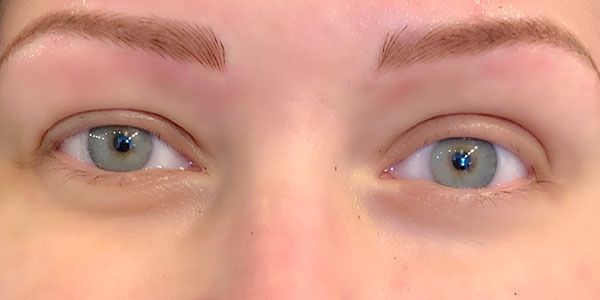 A close up of a woman 's eyes without makeup.