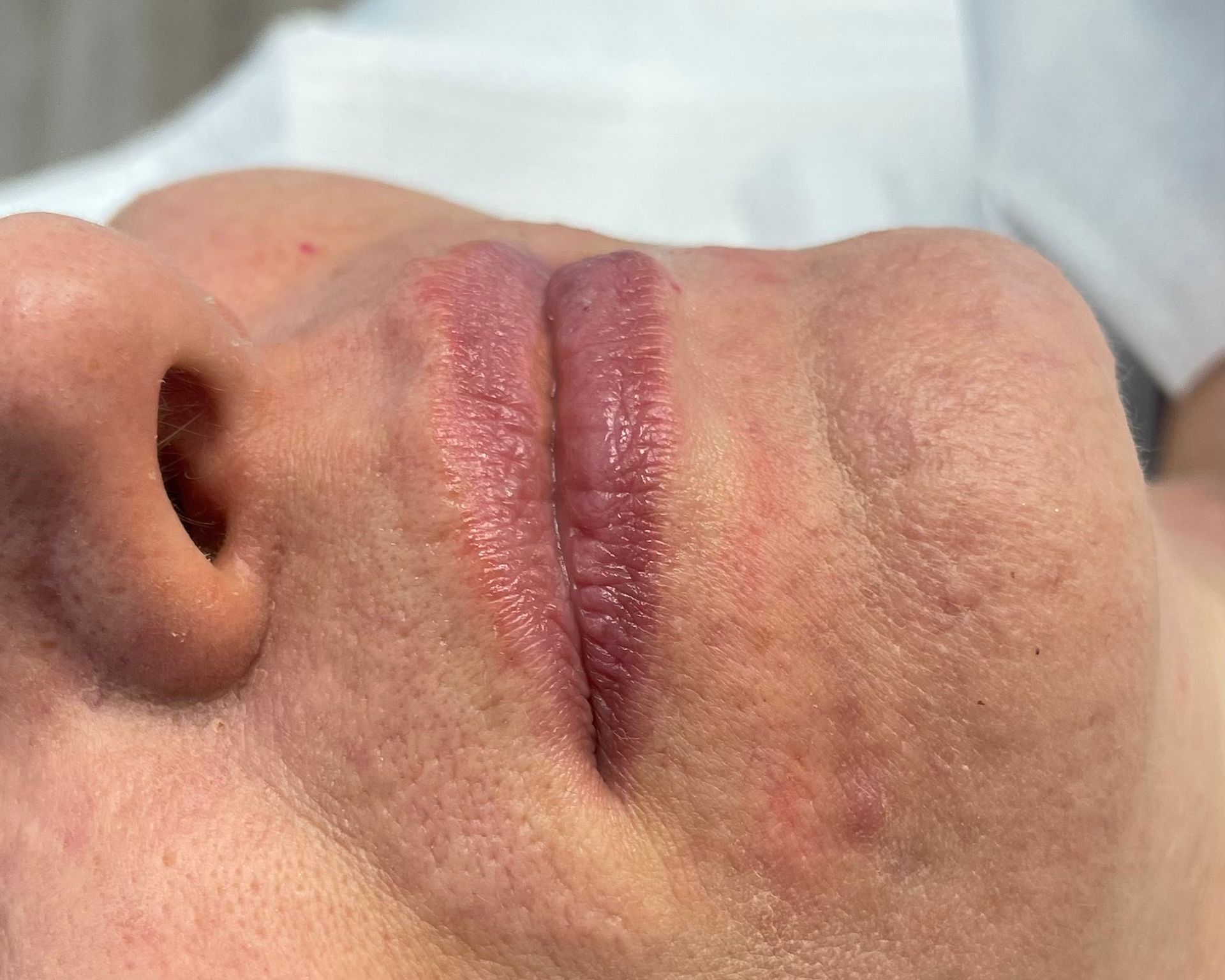 A close up of a woman 's face with her mouth open.