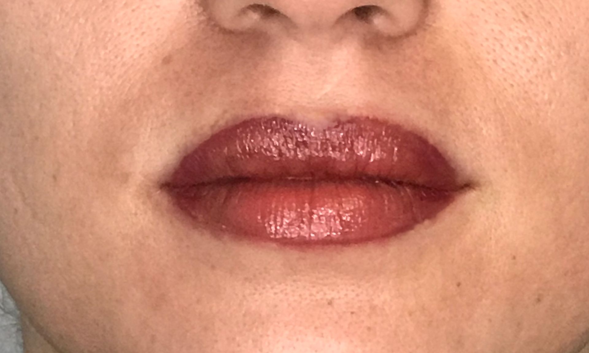 A close up of a woman 's lips with red lipstick.