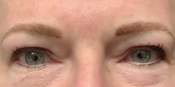 A close up of a woman 's eyes and forehead.