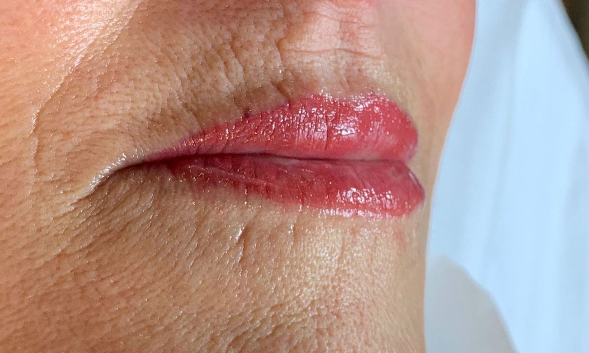 A close up of a woman 's lips with red lipstick.