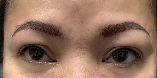 A close up of a woman 's eyes and eyebrows.