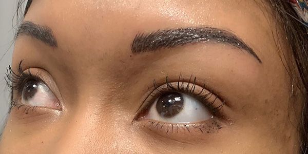 A close up of a woman 's eye with mascara on it.