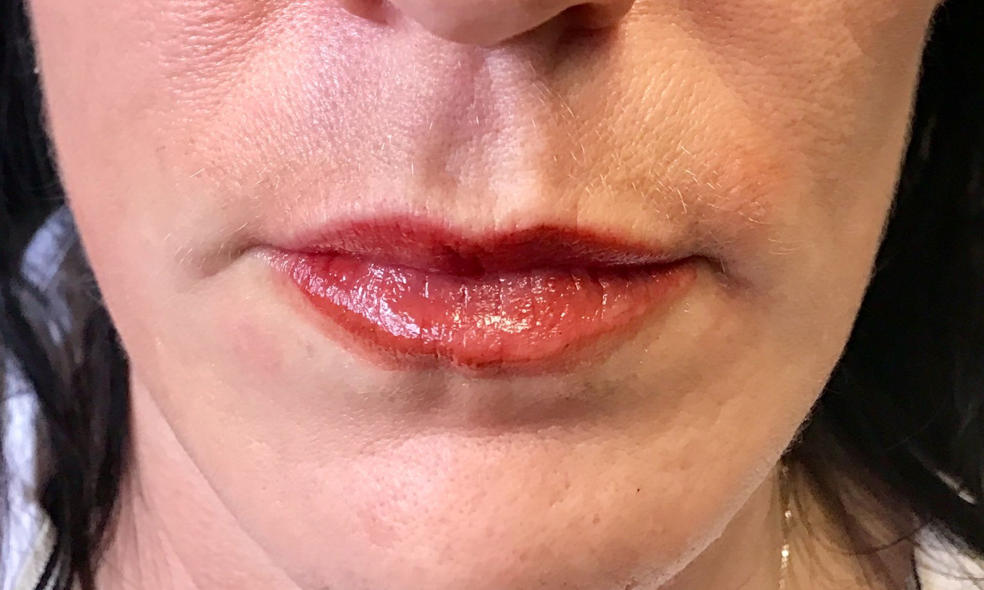 A close up of a woman 's lips with red lipstick.