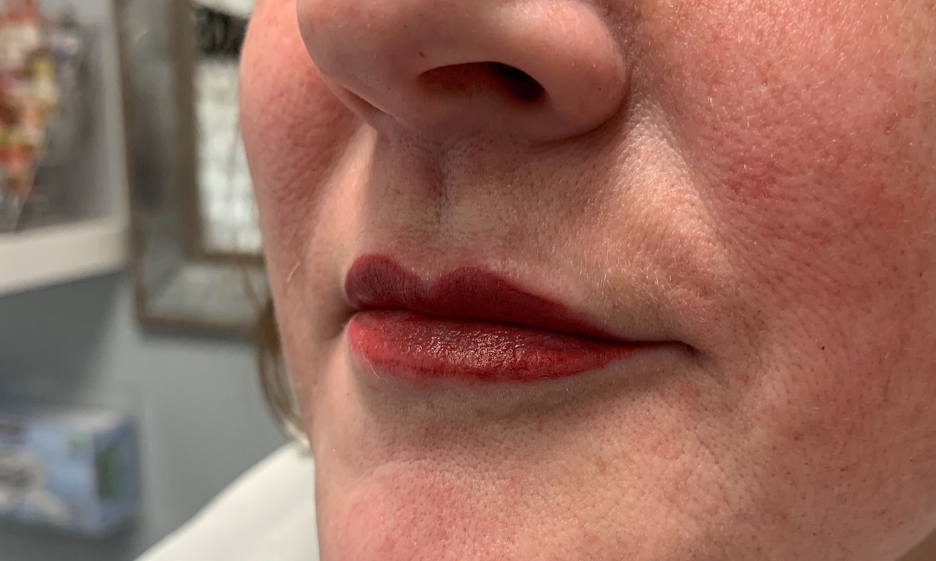 A close up of a woman 's lips with red lipstick.