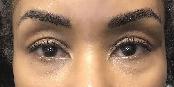 A close up of a woman 's eyes and eyebrows.