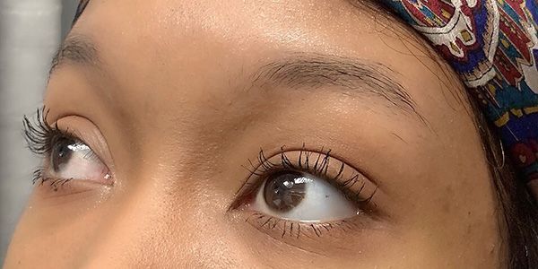 A close up of a woman 's eye with mascara on.