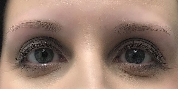 A close up of a woman 's eyes with makeup on.