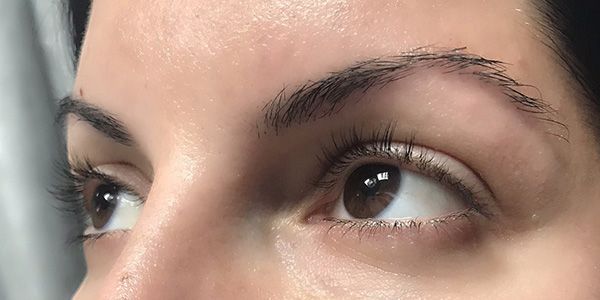 A close up of a woman 's eyes and eyebrows.