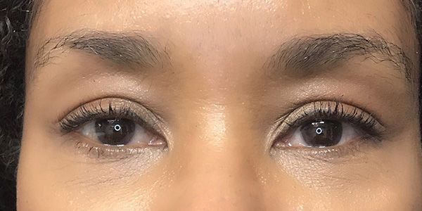 A close up of a woman 's eyes with makeup on.