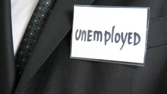 Name badge on suit coat with the word unemployed
