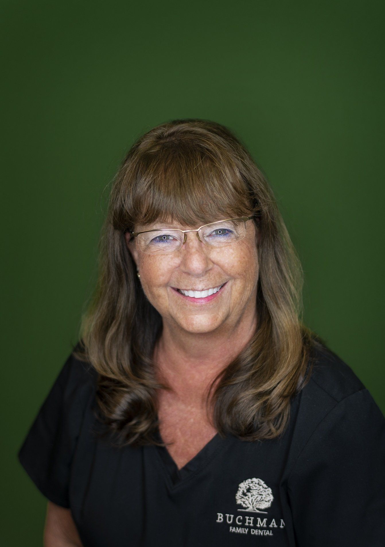 A woman wearing glasses and a black scrub top is smiling for the camera. Dental Hygienist Little Rock, AR