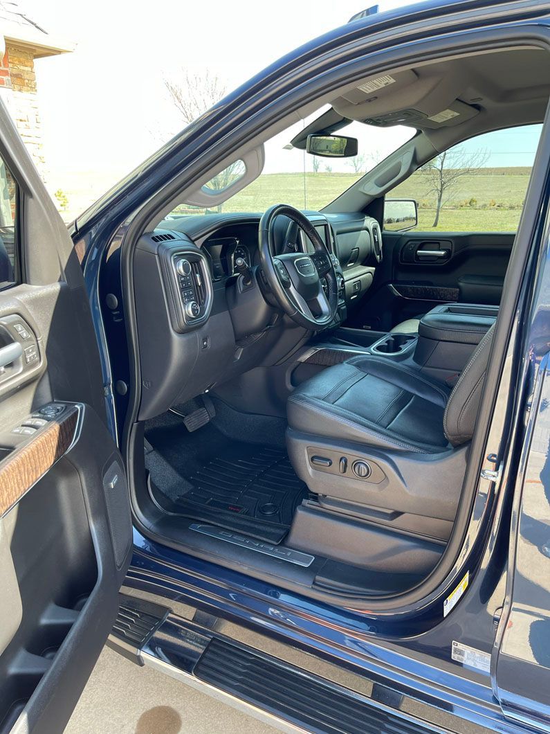 The inside of a blue truck with the door open.