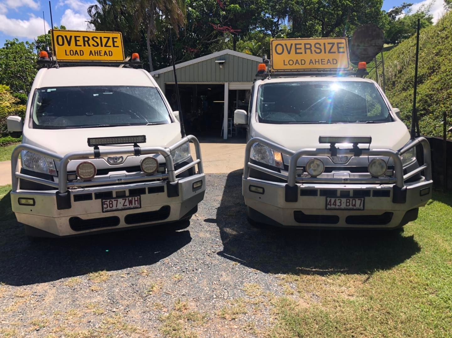 Two white pilot vehicles with