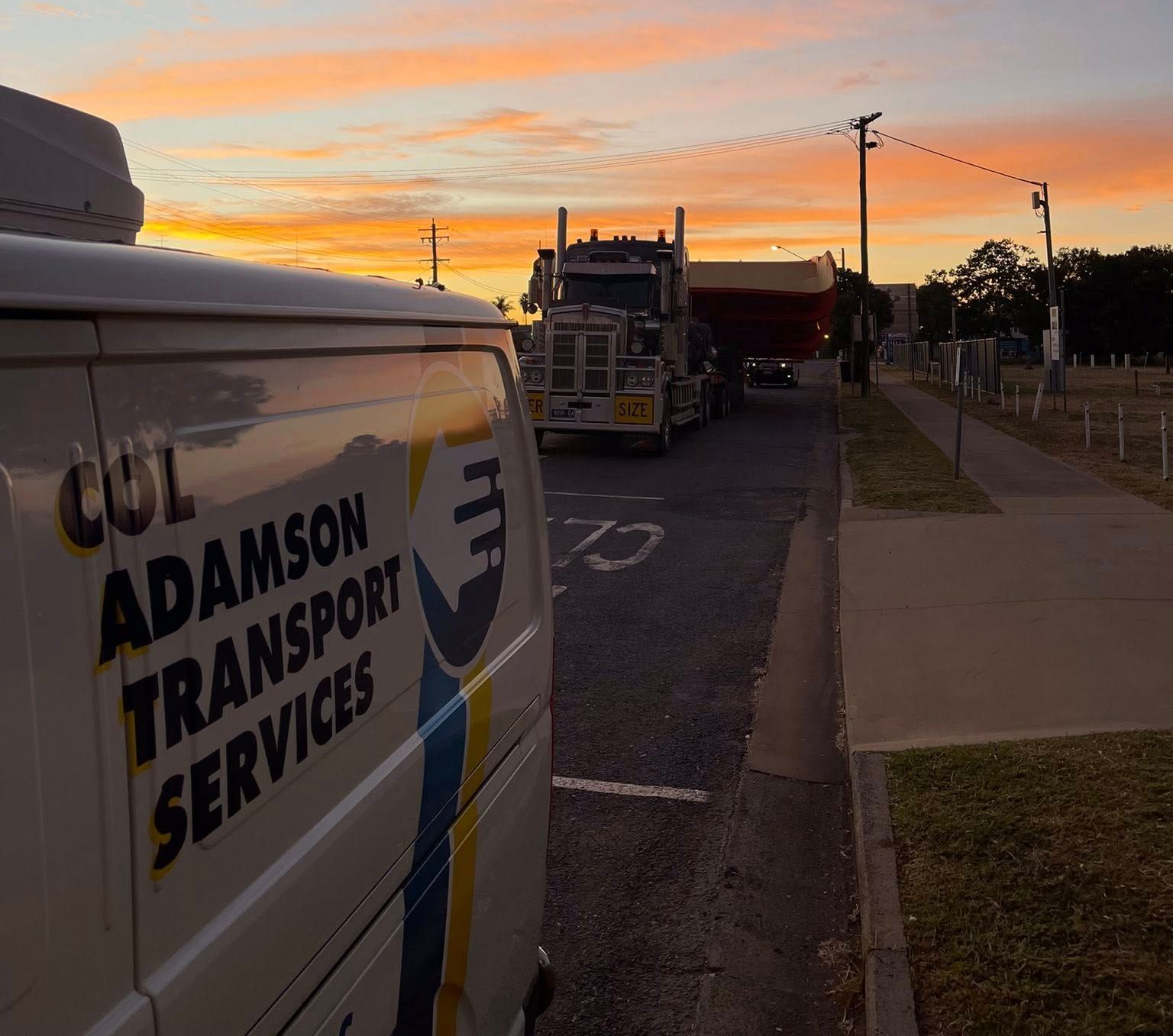 An Adamson Transport Services van parked on a street during sunset — Col Adamson Transport Services in Farleigh, QLD