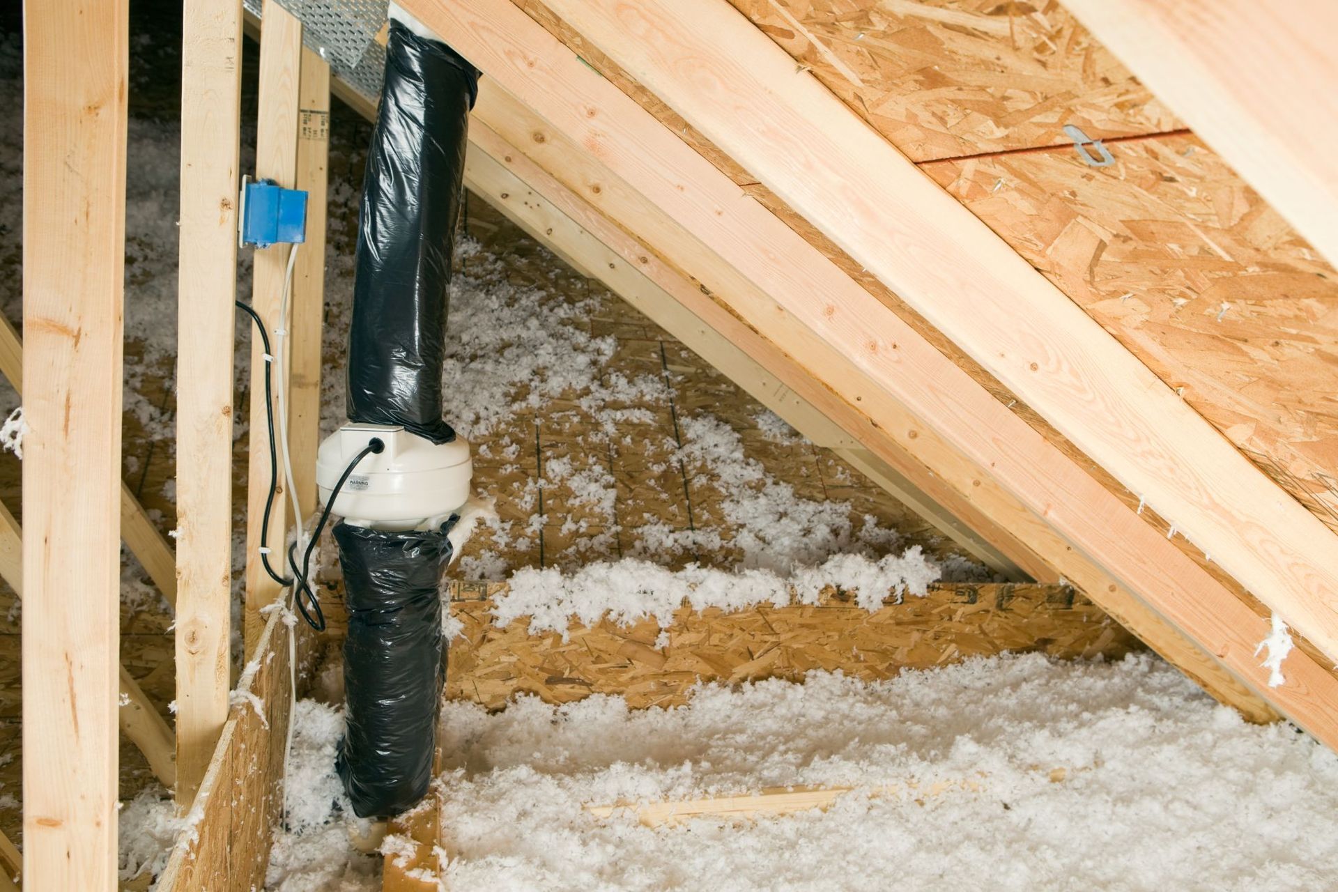 A pipe is sitting in the attic of a house under construction.