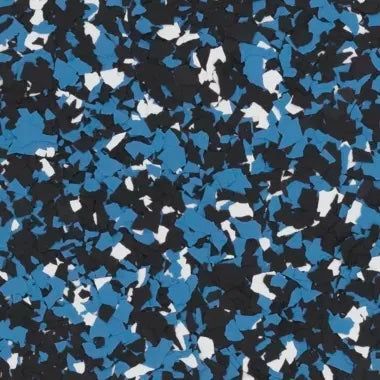 A close-up of decorative floor flakes in a mix of blue, black, and white irregular shapes.