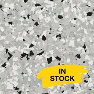 A speckled floor finish with white, grey, and black chips, featuring a yellow 