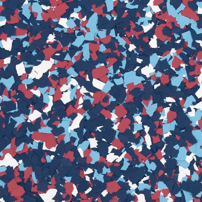 A dense pattern of small, jagged paint chips in shades of dark blue, light blue, white, and red.