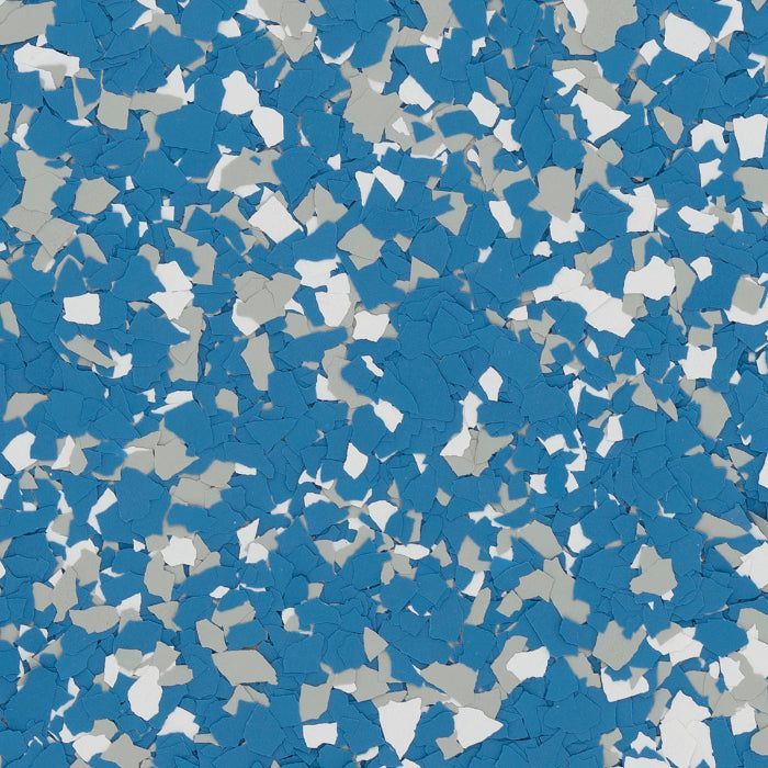 A close-up of a decorative flooring pattern featuring a dense mix of blue, light gray, and white vinyl paint chips.