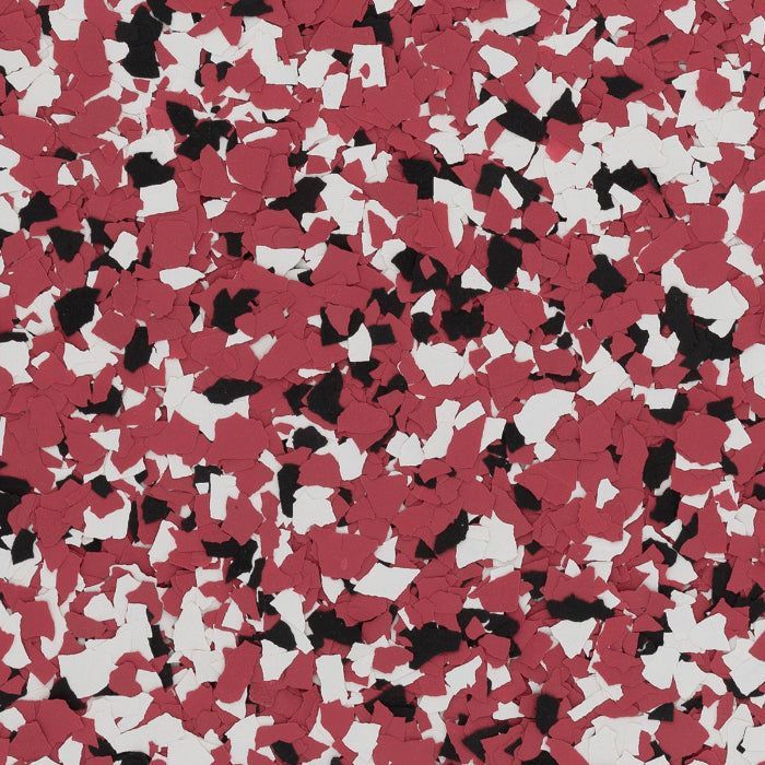 A pattern of scattered red, white, and black vinyl floor flakes.