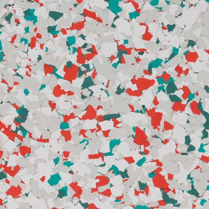 A flooring texture featuring a dense, multi-colored pattern of gray, white, red, and teal vinyl paint flakes.