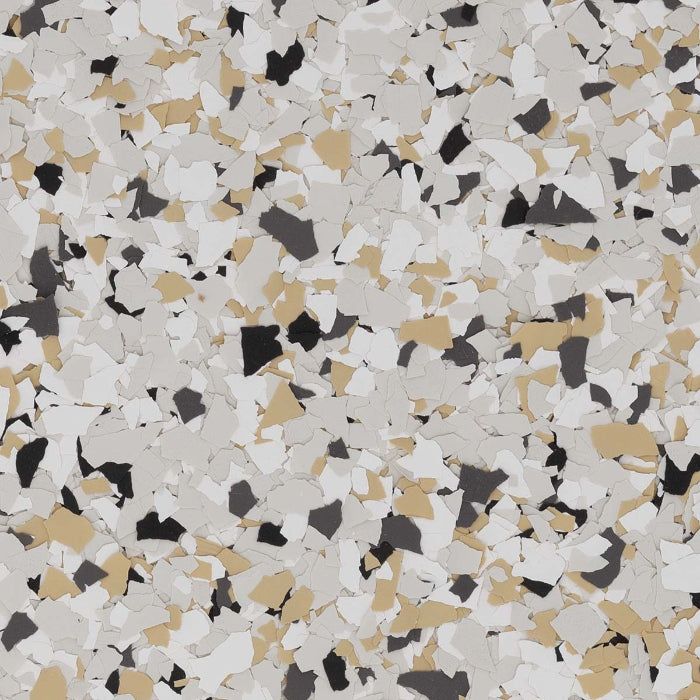 Decorative flooring chips in a mix of grey, tan, white, and black flakes, creating a speckled, multi-colored pattern.