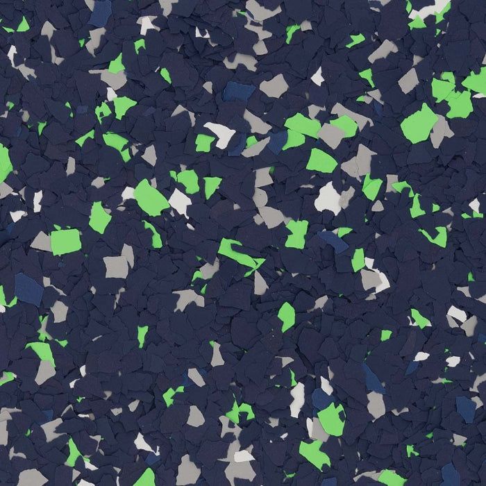 A close-up of decorative vinyl flooring chips in a mix of navy blue, bright lime green, and light gray flakes.